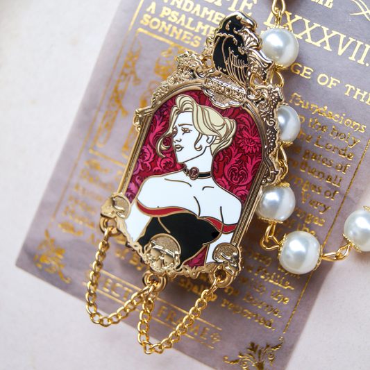 Enamel pin depicting a portrait of a woman with blonde hair and a low cut dress. Above her is a black raven and below her are golden skulls and chains. Behind the pin is a book page and pearls. 